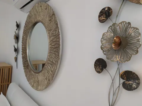 Camera: dettaglio specchio rotondo e decorazioni in metallo
